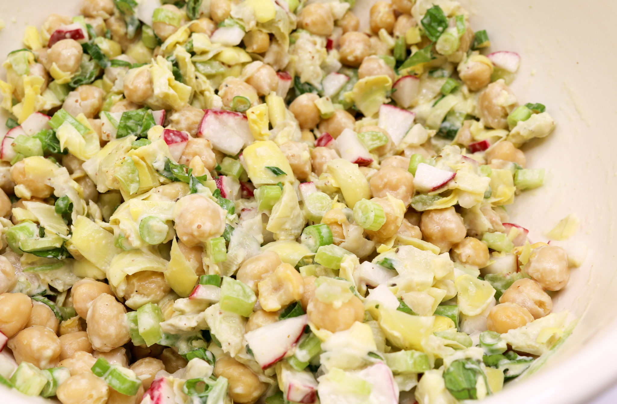 Artichoke chickpea salad is a fresh crisp treat. It is great for work or school lunches. Eat it in a bowl, lettuce cup, or on gluten-free bread. www.veganglutenfreelife.com/artichoke-chickpea-salad/